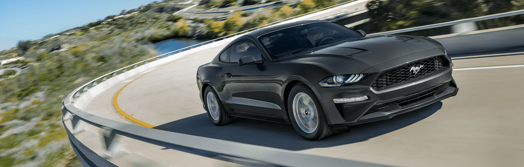 Ford Mustang cruising on scenic highway