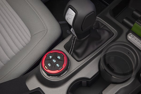Close up of Ford Bronco interior shifter and cupholders 