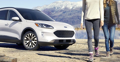 white 2021 Ford Escape front with 2 women walking past it