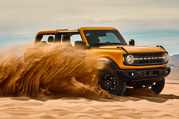 Ford Bronco being driven through the sand dunes
