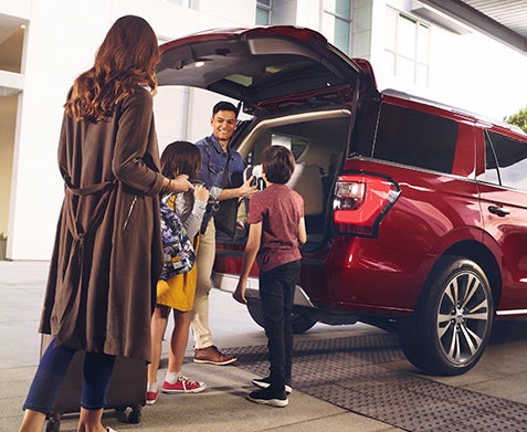 Family unpacking Ford Expedition